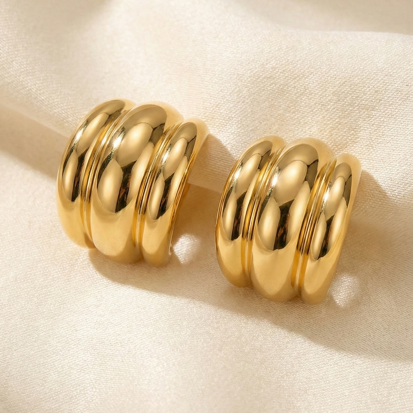Pair of gold hoop earrings. 