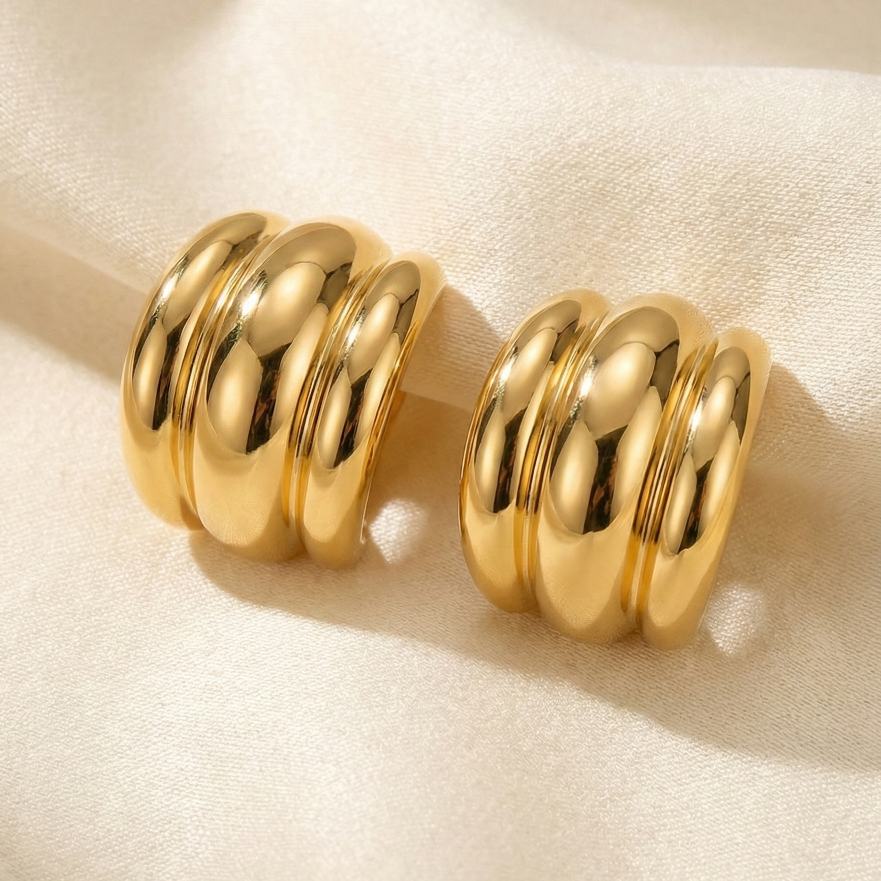 Pair of gold hoop earrings. 