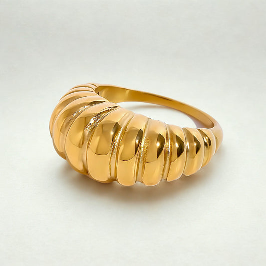 A gold-colored ribbed dome ring with a croissant-inspired silhouette.